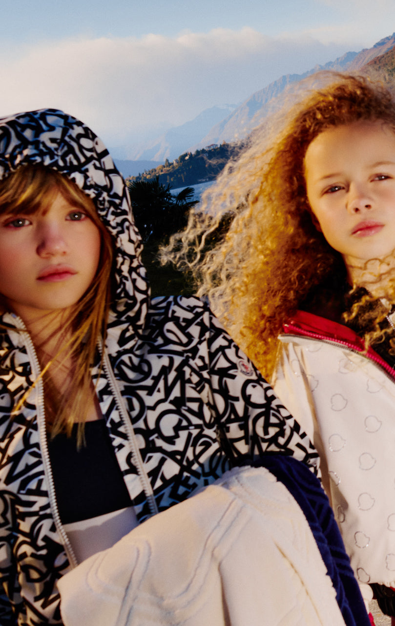 TWO GIRLS in moncler jackets marketing the new arrivals page for spring summer 2024 for kids atelier