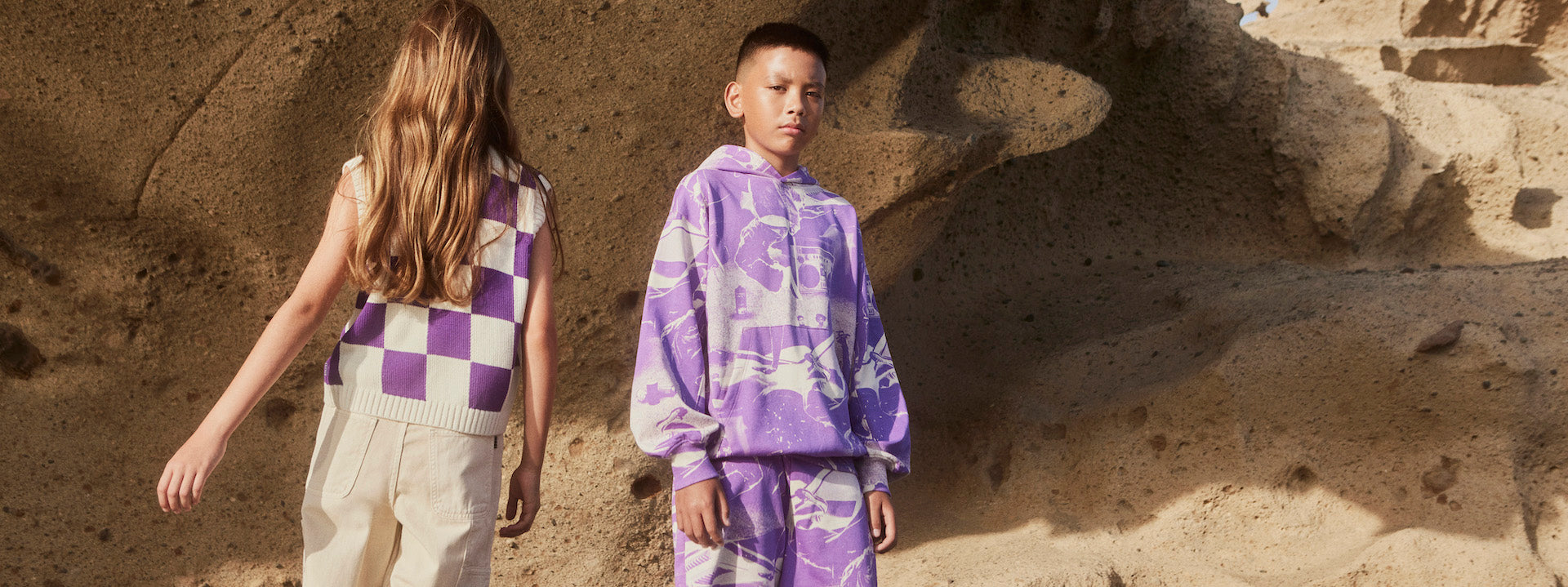 boy and girl wearing molo from kids atelier posing in desert promoting end of season sale 