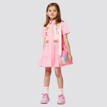 Girl wearing dress clothing from kids atelier posing in desert promoting end of season sale