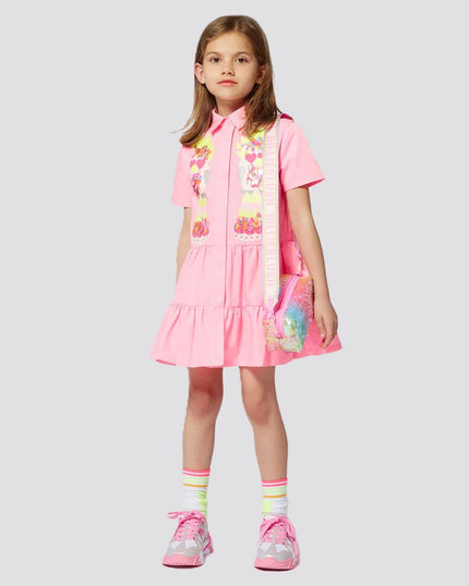 Girl wearing dress clothing from kids atelier posing in desert promoting end of season sale 