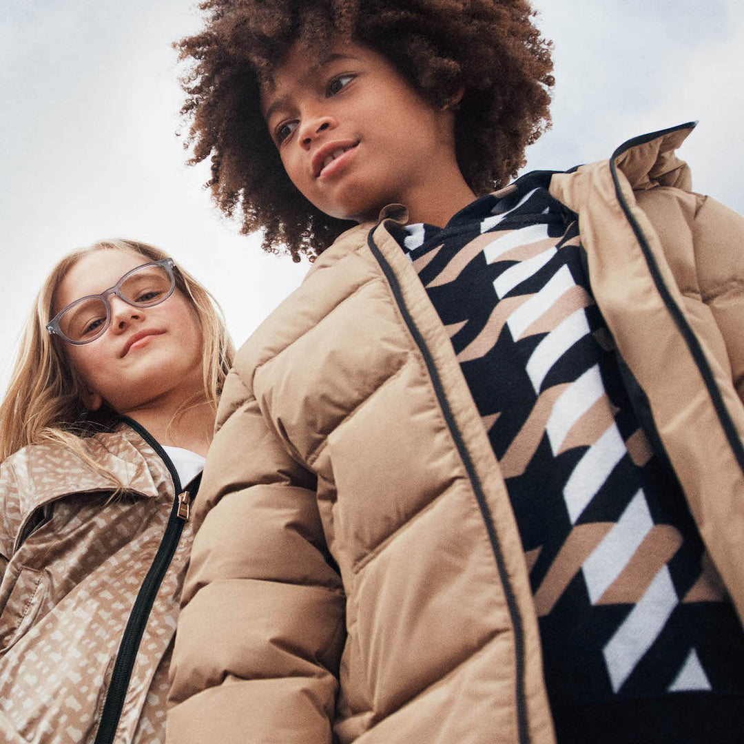 Boy and girl pausing in Boss fashion promoting cold weather apparel