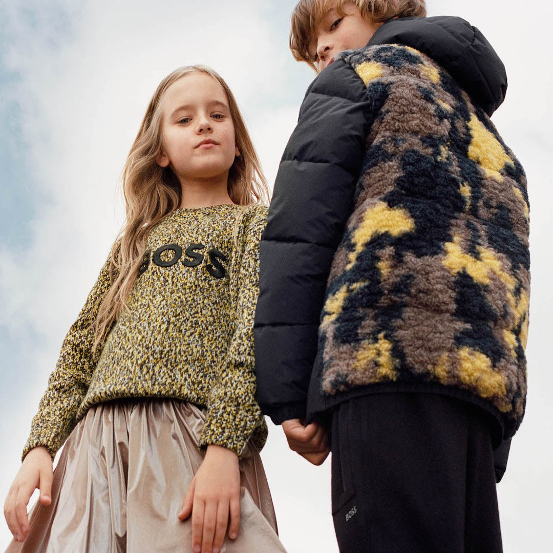 Boy and girl pausing in Boss fashion promoting Designer Must Have pieces collection