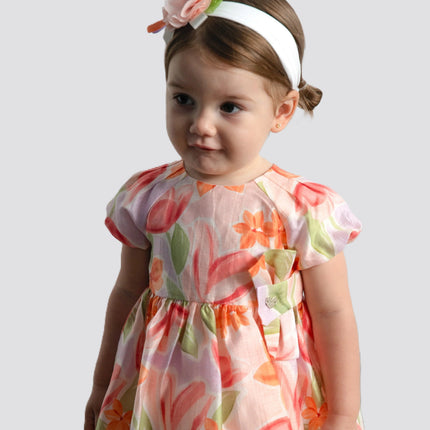 girl wearing baby clothing from kids atelier posing in desert promoting end of season sale 