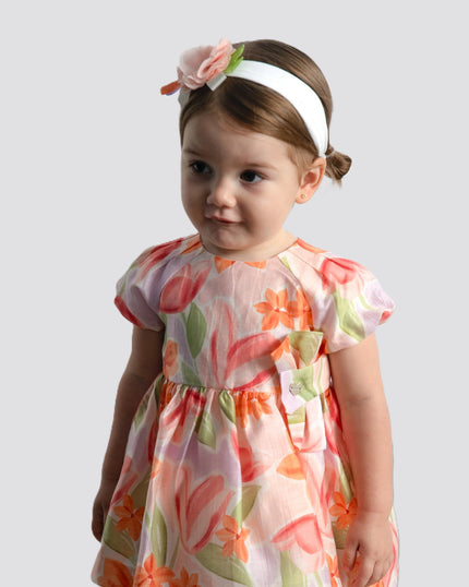 girl wearing baby clothing from kids atelier posing in desert promoting end of season sale 