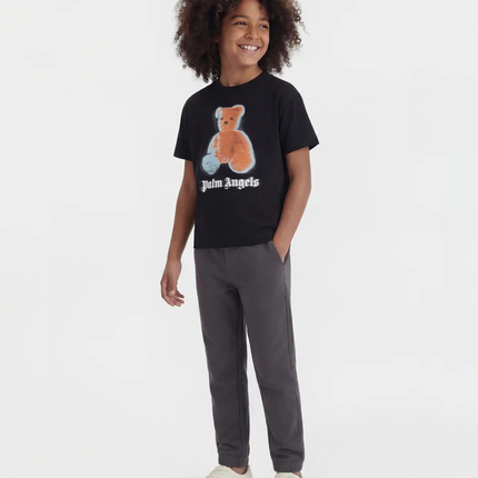 boy wearing clothing from kids atelier posing in desert promoting end of season sale 