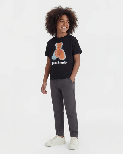 boy wearing clothing from kids atelier posing in desert promoting end of season sale 
